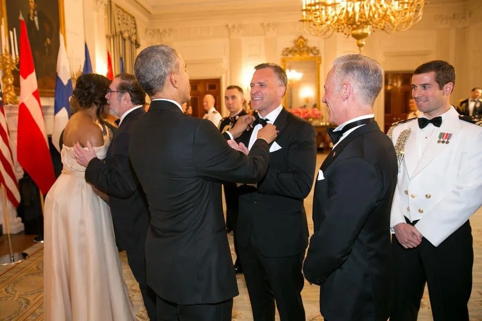 Image of President Obama straightening Rufus' bowtie at the Nordic State dinner at the White House.