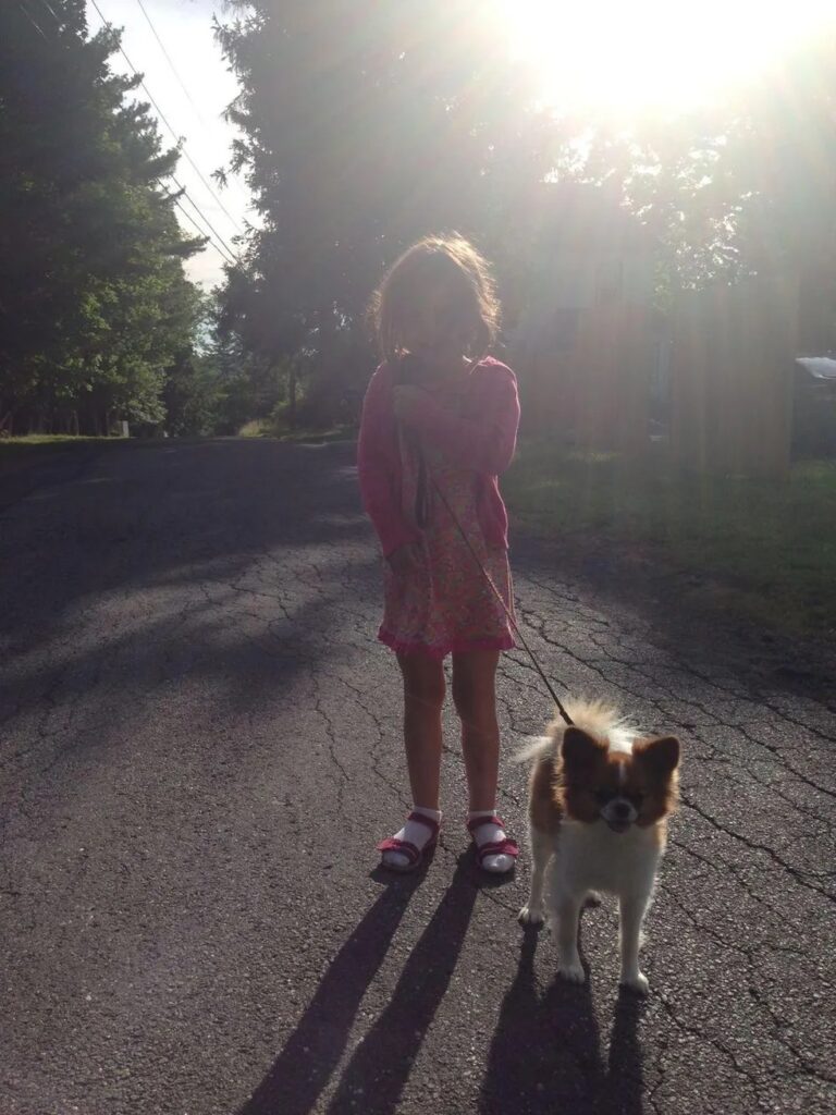 Image of the author's daughter, Cecily, taking Henry for a walk.