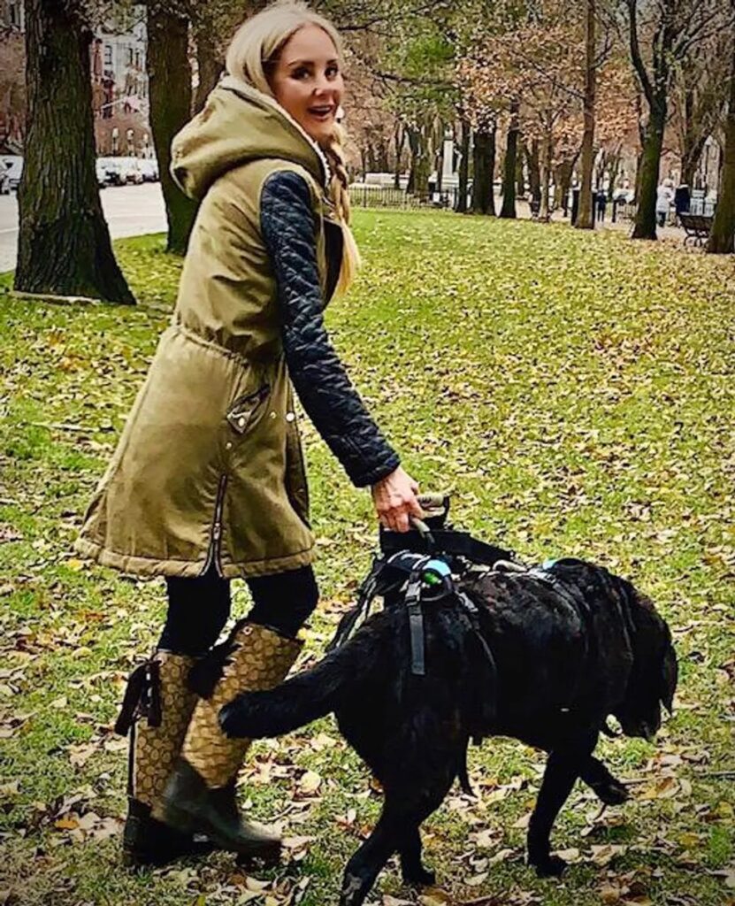 Jenna walking Woodrow with a Help 'Em Up Harness.